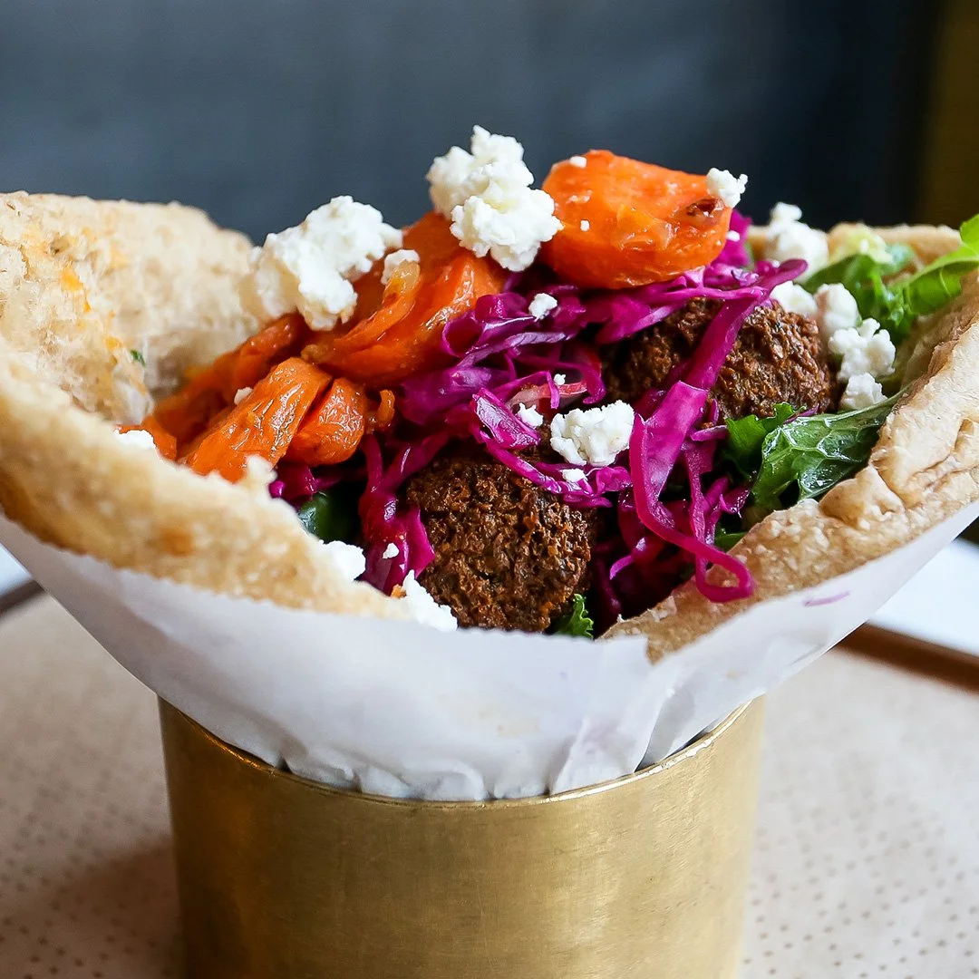 Brassica signature dishes  Build-Your-Own Pita Sandwiches or Salads (with fillings like Falafel, Chicken Shawarma, or Brisket), Special Fries with spicy sauce, Brassica Hummus.